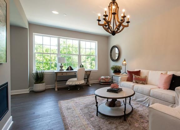 a living room with a white couch and a table at Countryside Townhomes, Countryside, IL