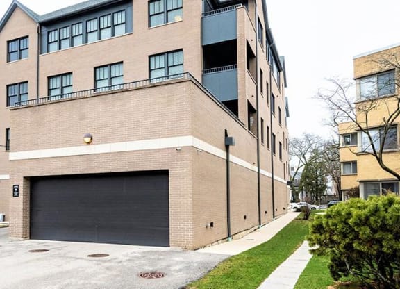 a large brick building with a garage door at Wilmette 1121, Wilmette, IL