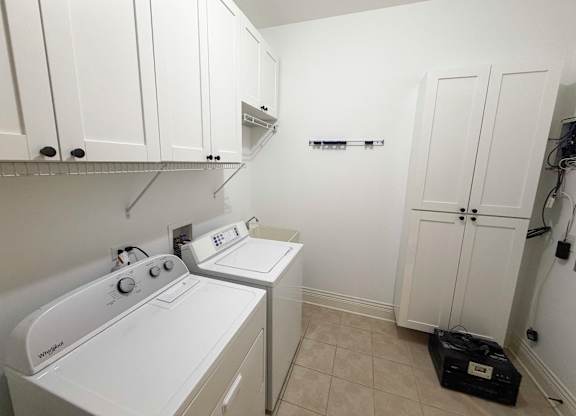 A small laundry room with a washer and dryer.