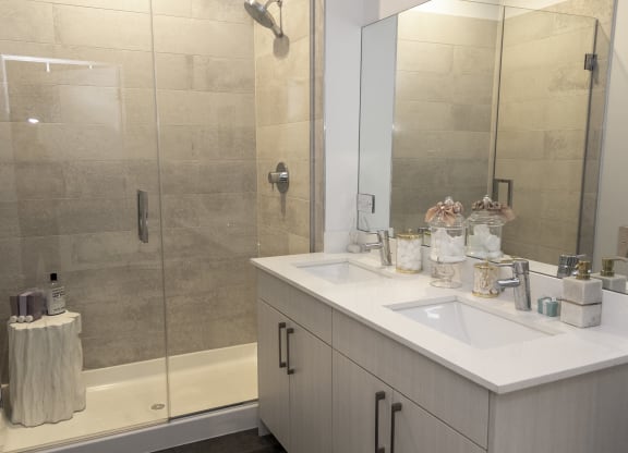 a bathroom with a shower and a sink and a mirror