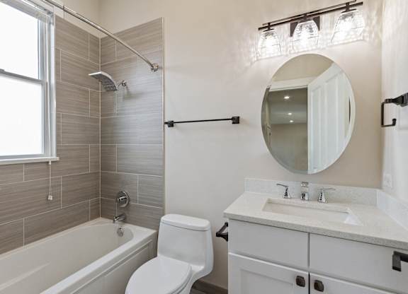 a bathroom with a sink toilet and a bath tub