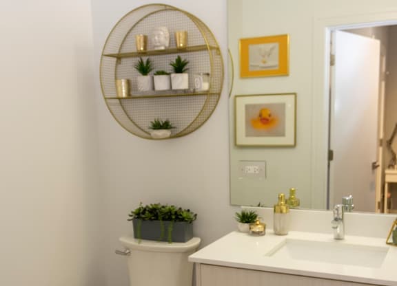 a small bathroom with a toilet and a sink and a mirror