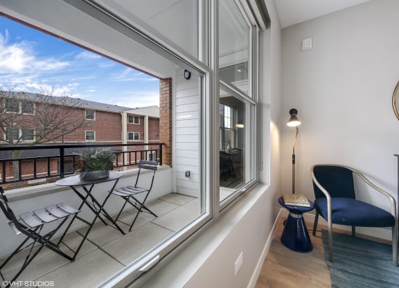 a balcony with a chair and a table and a large window at Clarendon Hills 229, Illinois