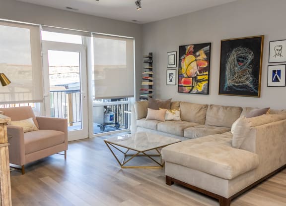 a living room with a couch and a chair and a table