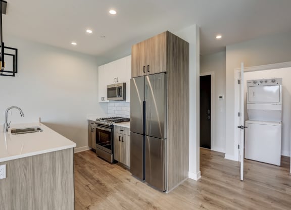 a kitchen with stainless steel appliances and a refrigerator