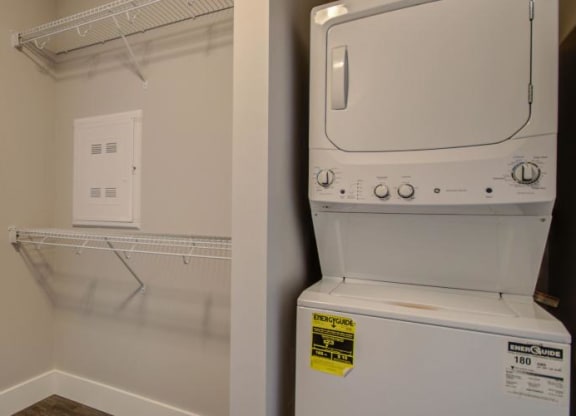 a white washer and dryer in a room next to a bedroom at Barrington 101, Illinois, 60010