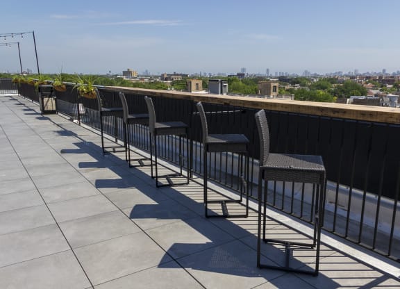a row of chairs on a roof overlooking a city at Talman 1554, Chicago