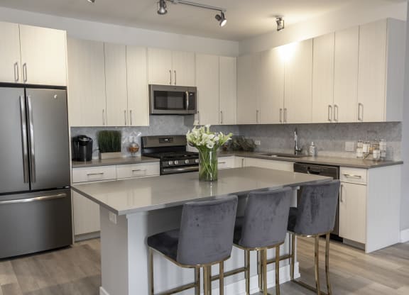 a kitchen with stainless steel appliances and white cabinets