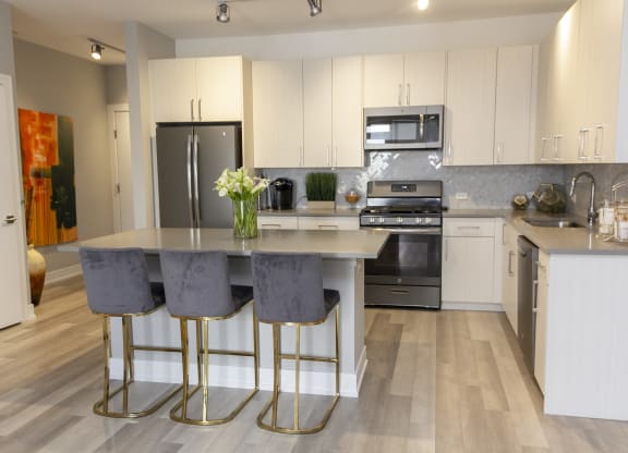 a kitchen with stainless steel appliances and white cabinets