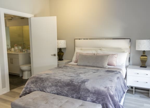a bedroom with a bed and a bathroom