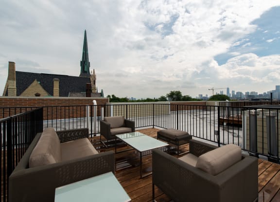 a rooftop deck with furniture and a view of the city  at Tripp 4321, Chicago, 60641