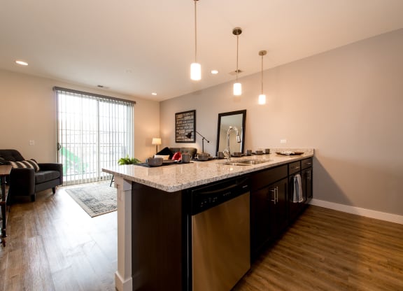 a kitchen with an island and a living room with a couch