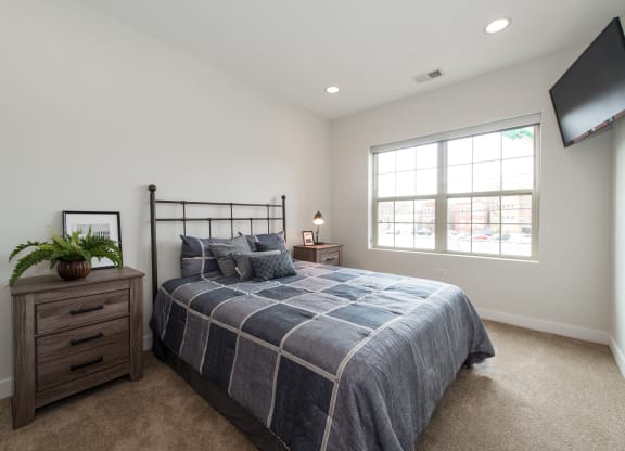 a bedroom with a bed and a window