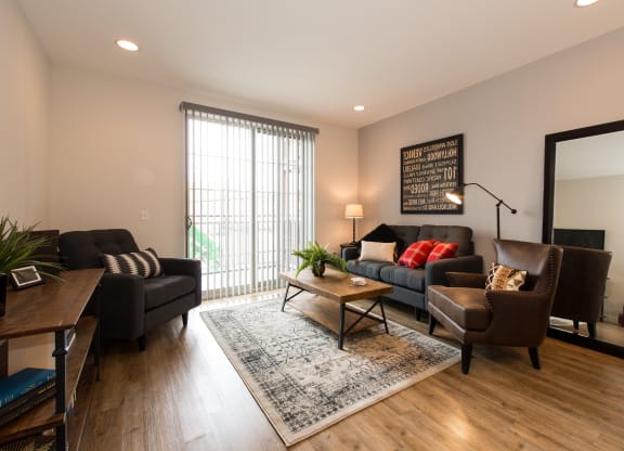 a living room with a couch and chairs and a table
