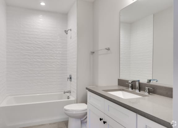 a bathroom with a sink toilet and a shower