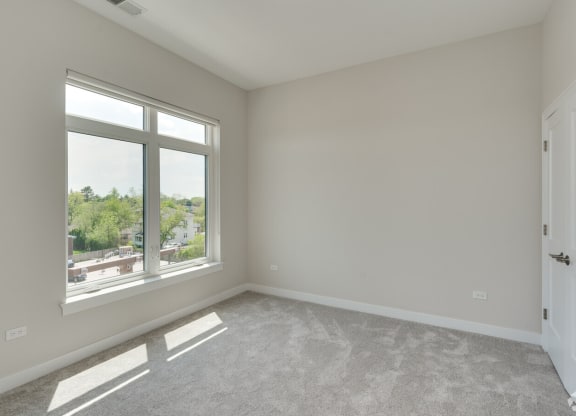 an empty living room with a large window