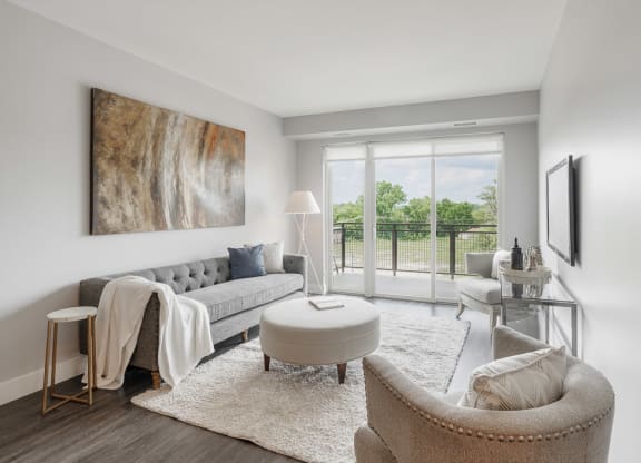 a living room with a couch and a chair and a balcony at Barrington 101, Barrington, IL 60010