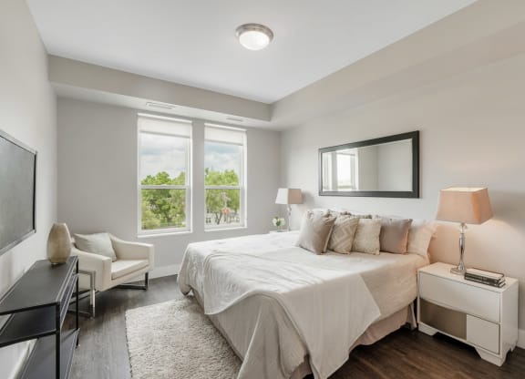 a white bedroom with a bed and a tv at Barrington 101, Illinois