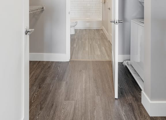 a white bathroom with a toilet and a walk in closet at Barrington 101, Chicago
