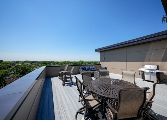 a patio with a table and chairs on a roof