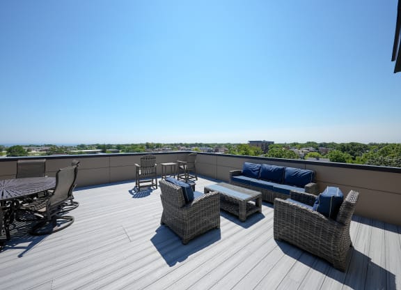 a roof deck with furniture and a view of the city