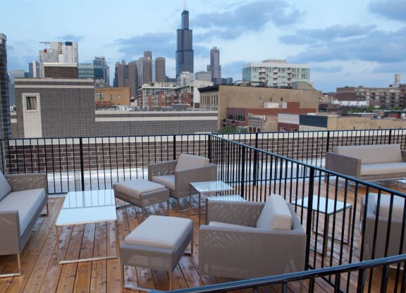 a rooftop deck with furniture and a city in the background  at Tripp 4321, Chicago, 60641