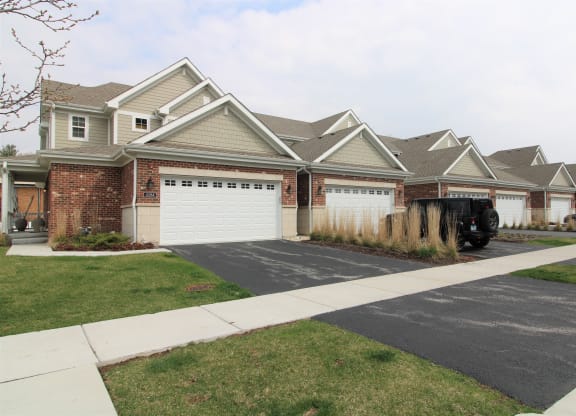 a house with a white garage door in front of it at Countryside Townhomes, Countryside, IL
