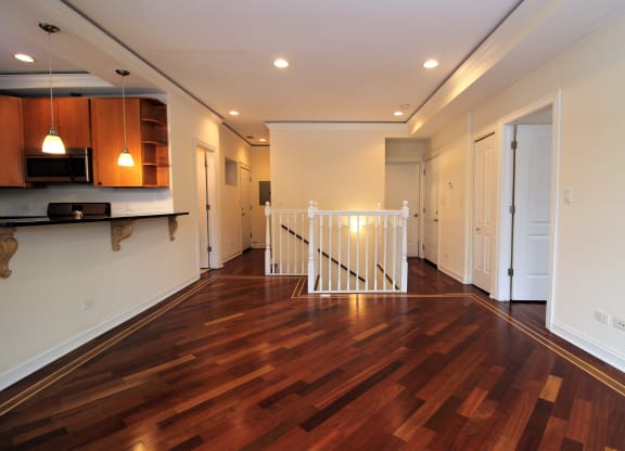 a living room with a hard wood floor and a staircase