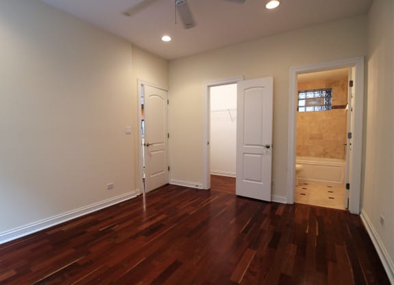 a living room with a hard wood floor and two doors
