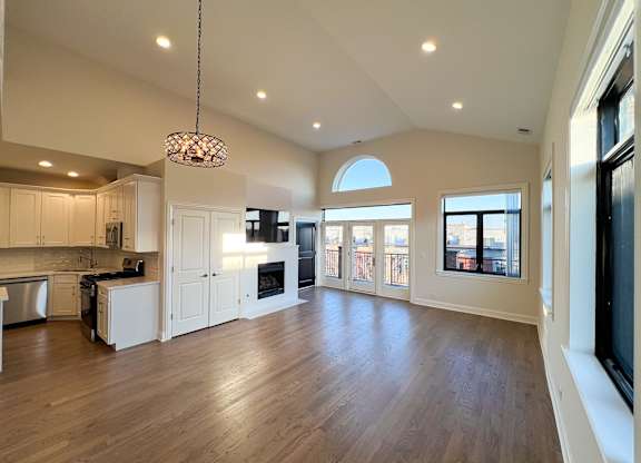 A modern kitchen with wooden floors and a large island.