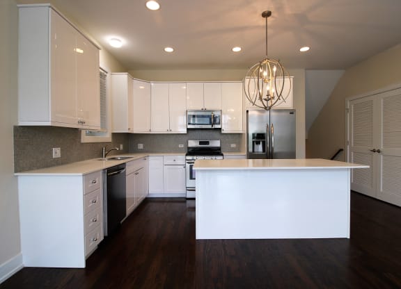 a kitchen with white cabinets and a white counter top