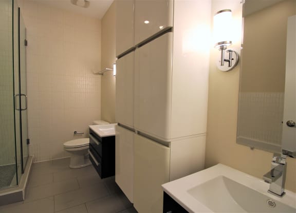a small bathroom with a shower and a sink and a toilet