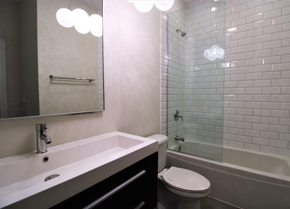 a bathroom with a sink and a toilet and a shower
