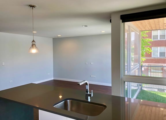 an empty kitchen with a sink and a window