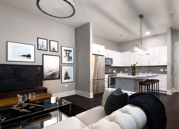 a living room with a white couch and a kitchen