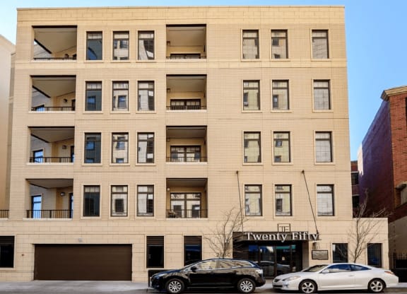 a large tan building with cars parked in front of it  at Clark 2050, Chicago, Illinois