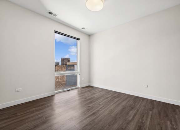 Bright bedroom at Highpoint Buena Park on Broadway, part of a selection of modern 1, 2, 3, and 4-bedroom apartments in Chicago’s Buena Park neighborhood, featuring large windows and contemporary finishes