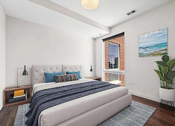 A bedroom with a large bed and a painting on the wall.