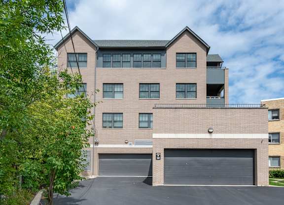 A large two-story building with a garage door in front.