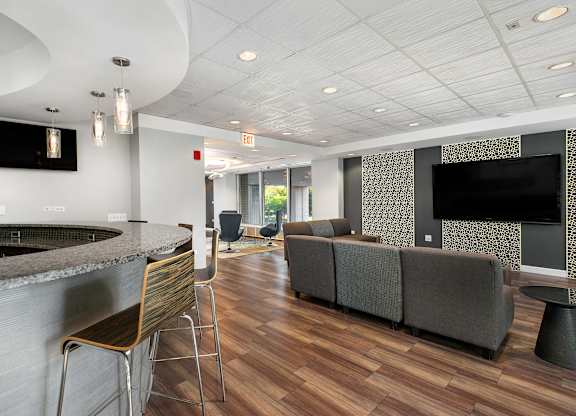 A modern living room with a bar area and a television.
