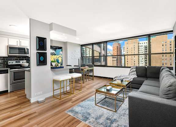 A modern living room with a grey couch and a coffee table.