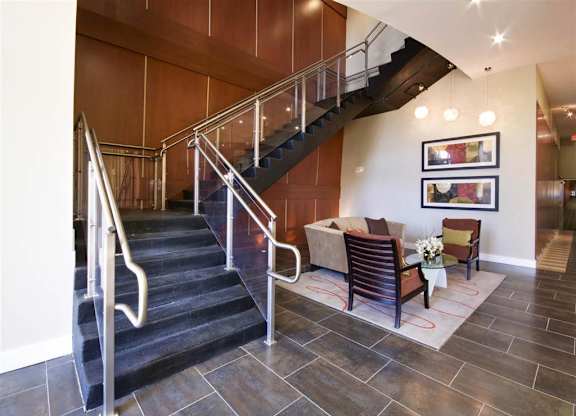 A staircase with a metal railing and wooden steps.