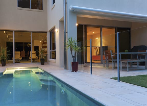 a swimming pool in the backyard of a house