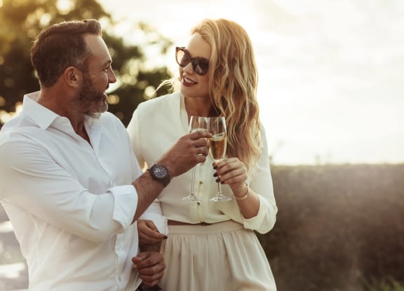a man and a woman holding glasses of wine