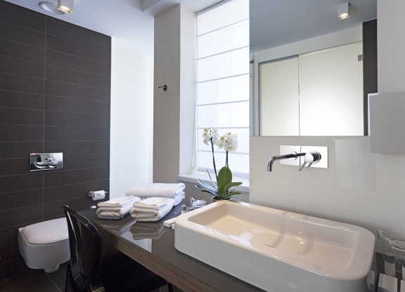 a white bathroom with a sink and a window