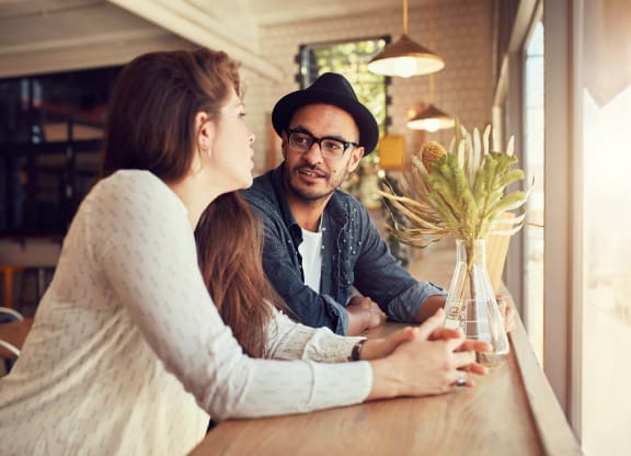 a man and woman sitting at a table in a restaurant