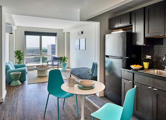 A modern kitchen with a dining table and chairs.