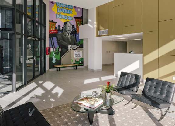 A room with a glass table and two chairs.