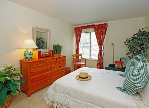 a bedroom with a bed and a dresser in it