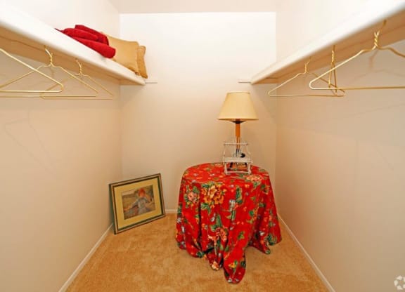 a closet with a table and a lamp in it